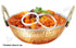 Copper and stainless steel hammered kadai bowl in use, filled with aromatic Indian curry