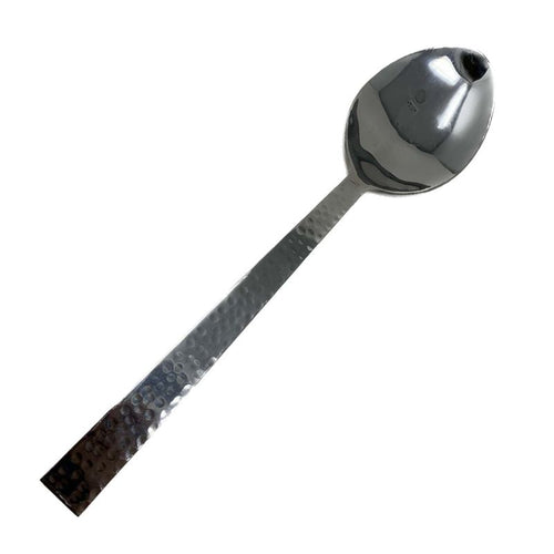Stainless steel oval serving spoon with hammered handle on white background
