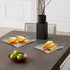 Triangular platter showcasing fruits, bread, or salads