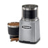 Waring WSG60 3-cup grinder with removable bowl and easy-pour spout beside whole spices and nuts