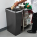 Slim rectangular black trash can in commercial kitchen